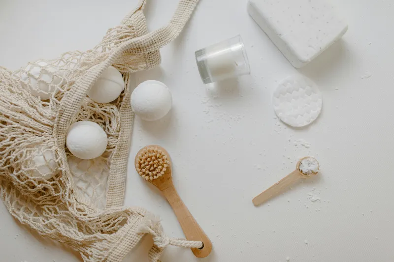 Split comparison showing cluttered bathroom counter with many products versus minimalist setup with three essential products
