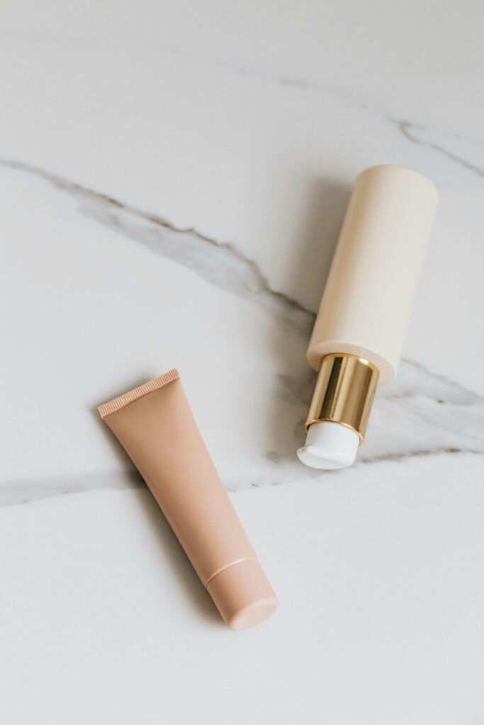 Essential skincare products including cleanser, serum, moisturizer, and sunscreen arranged on white background